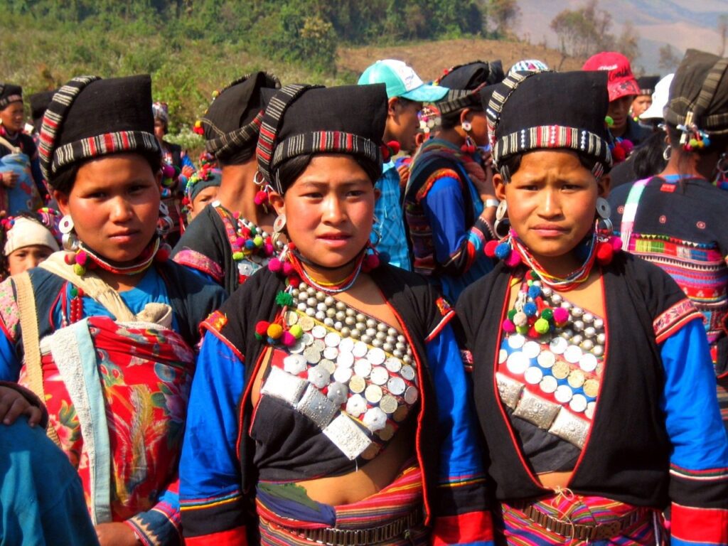 Scenic view of Phongsaly Province in Northern Laos, showcasing terraced rice fields, dense forests, and mist-shrouded mountains.