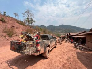 Motorcycle touring through scenic landscapes in Laos, highlighting the country’s natural beauty and rural charm.